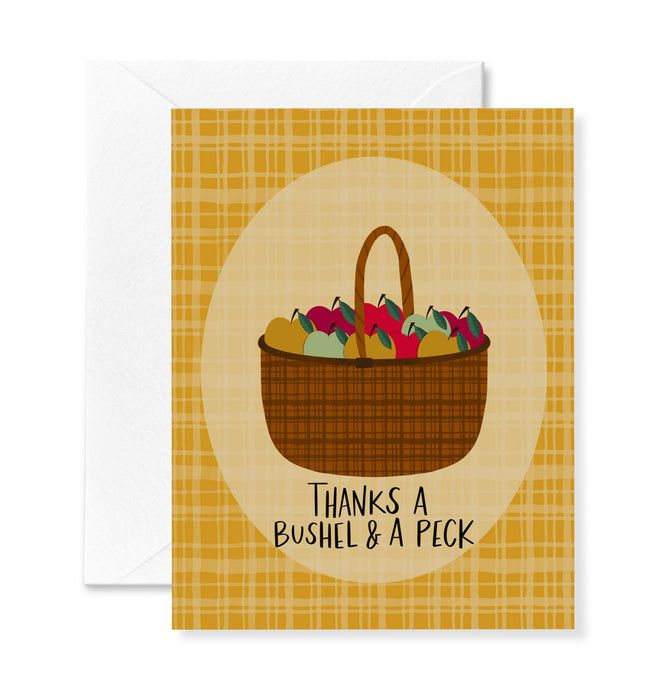 Greeting card with a basket of apples and plaid design, featuring the text 'Thanks a bushel & a peck'.