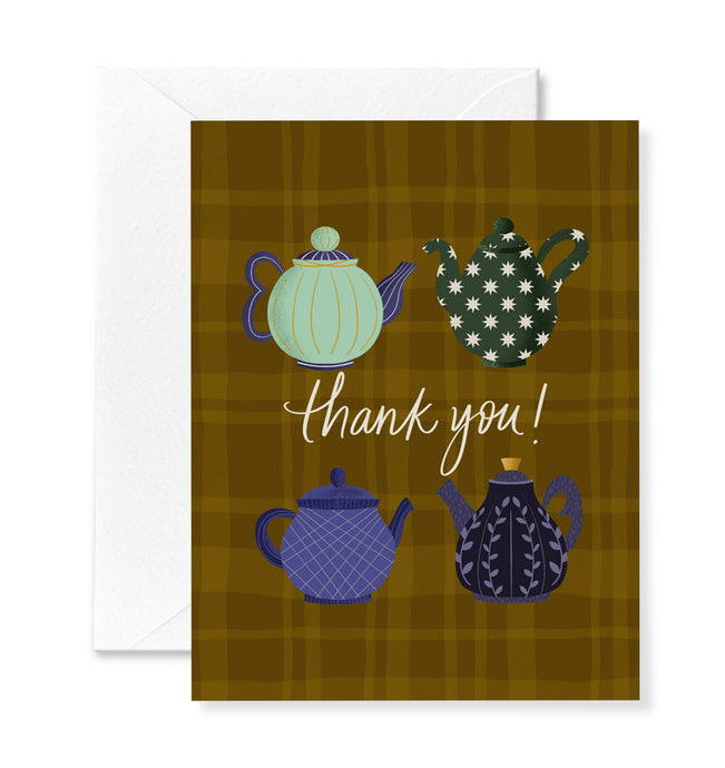Greeting card with teapot illustrations and 'thank you!' text on a plaid background
